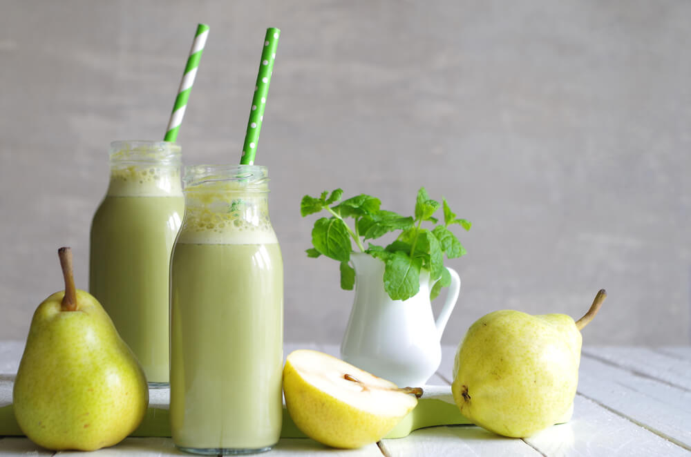 Dvě sklenice zeleného hruškového smoothie s meduňkou